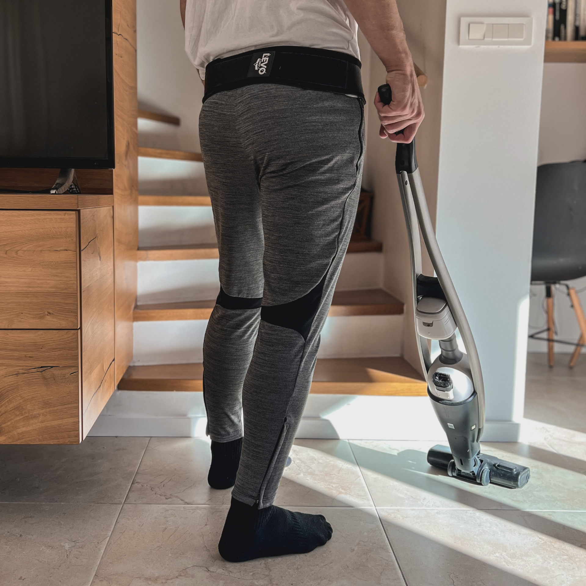 Person wearing the Levo Belt while doing light housework